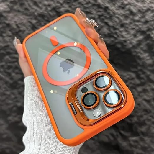 A close-up of a hand holding an orange and clear phone case designed for a smartphone, featuring a circular design for MagSafe compatibility and a dual-camera cutout on the back. The case has a glossy finish and is set against a textured, gray background.
background